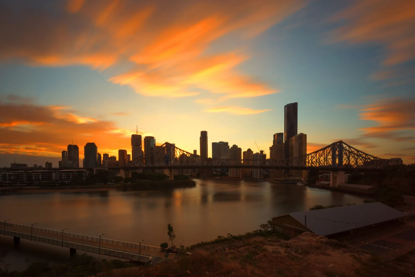 Story Bridge and the Brisbane skyline at sunset over the Brisbane River — Queensland solar and battery rebate information
